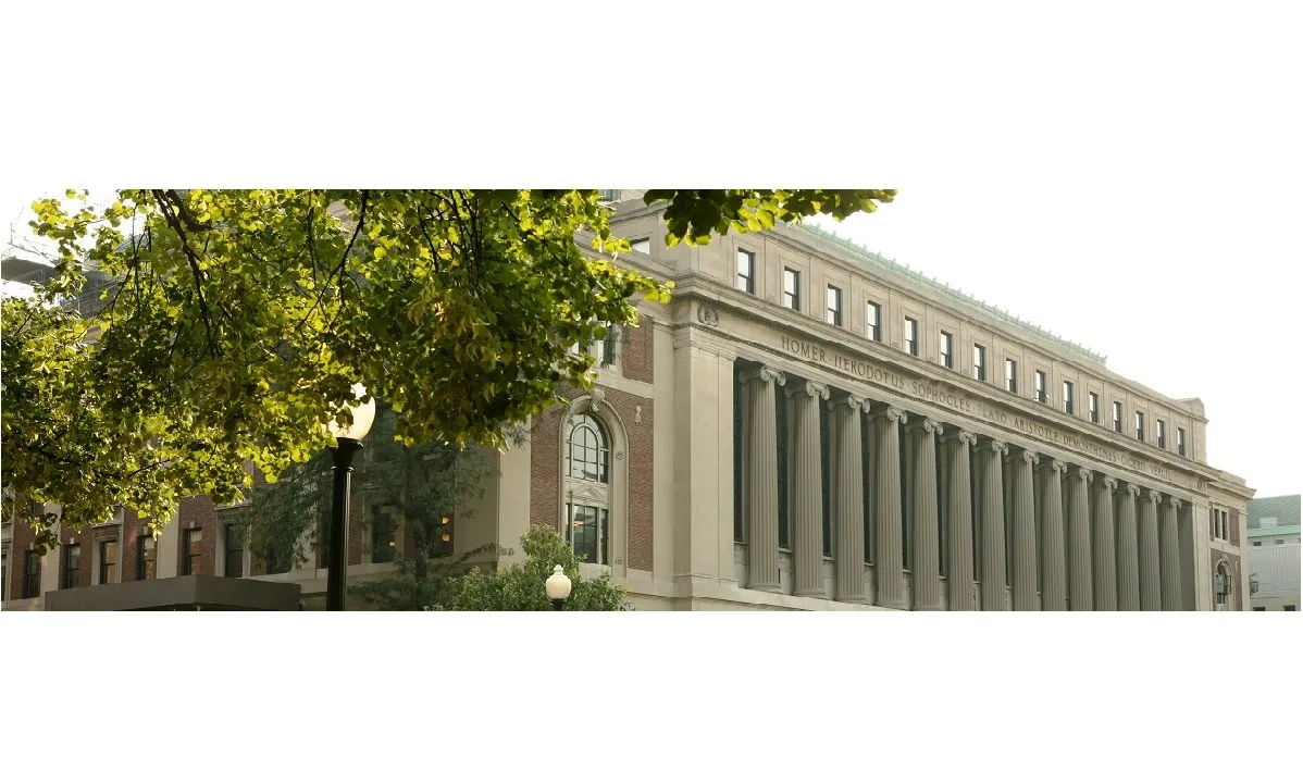 Butler Library with author names inscribed into the edifice, tree in foreground 
